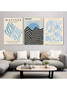 two posters on the wall above a couch in a living room, one with an ocean theme