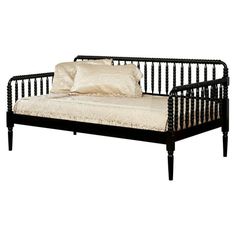 a black daybed with a white pillow on it's back and side rails