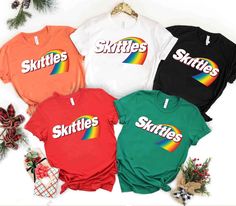 Skittles T-shirt Halloween Costume, Teacher Group Halloween Shirts, School Matching Halloween Costume, Candy Halloween Shirt a Large Group --------------------------------------------------------------------------------- It's not easy to satisfy everyone when it comes to apparel, especially when choosing one as a gift - unless you opt for our personalized apparel. A personalized shirt is a perfect gift for all occasions and makes your loved one feel even more special. ღ INFORMATION: - If you want to print the side, there will be an additional fee for printing the back side. - If you want a custom design, please message us or you can write it in the personalized box. We will design according to your needs. - We have Brand Gildan - If you enter the wrong address with your order, we will try Skittles Halloween Costume Group, Skittles Halloween Costume, M&m Group Halloween Costumes, Tshirt Halloween Costumes Group, Group Halloween Shirts For Teachers, Matching Halloween, Personalized Clothes, Costume Halloween, Halloween Tshirts