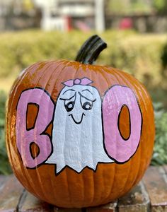 a pumpkin with the word boo painted on it