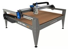 an easy milling machine is sitting on a table with no wheels or legs, and has a brown paper under it