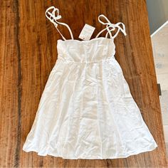 White Mini Sundress Perfect For Summer Adjustable Bow Tie Straps 24” Long (Excluding Straps) Show Me Your Mumu White A-line Sundress With Tie Straps, White A-line Mini Dress With Tie Back, White A-line Dress With Tie Straps, White Linen Mini Dress For Daywear, White A-line Mini Dress For Vacation, White Linen A-line Mini Dress, White Summer Mini Dress With Tie Straps, White Sundress With Tie Straps For Brunch, Fitted White Sundress With Tie Straps