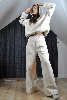 This is a super cool pair of modern tracksuit pants. Very flattering, trendy loose flared cut. Elasticated waist with inside drawstring. It has got a stitched crease for modern edgy look.  The color is very flattering to any complexion as it is glowy warm off white, natural.  The fabric is very high quality, made in Poland, with added hemp for its incredible properties (strength, absorbency, breathability, antimicrobial, sustainability). Here is a matching hoodie: https://www.etsy.com/listing/16 Beige Relaxed Fit Wide Leg Sweatpants, Beige Relaxed Fit Wide-leg Sweatpants, Beige Wide Leg Relaxed Fit Sweatpants, Beige Wide-leg Relaxed Fit Sweatpants, Cream Wide Leg Relaxed Fit Sweatpants, Cream Wide-leg Relaxed Fit Sweatpants, Beige Wide Leg Sweatpants For Streetwear, Beige Wide-leg Sweatpants For Streetwear, Casual Cream Wide Leg Cotton Pants