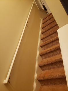 an open door leading up to a set of stairs with carpet on the bottom and bottom