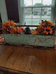 an old window box filled with flowers and pine cones