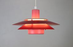 a red light hanging from a ceiling fixture