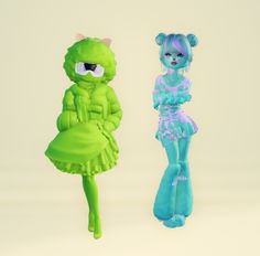 two green and blue dolls standing next to each other in front of a white background