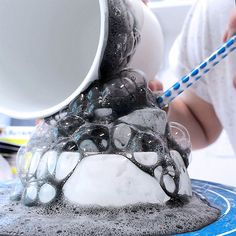 a toothbrush is being held in front of an ice sculpture