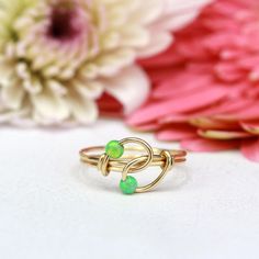 A Unique handmade Opal ring thats also the perfect combination between Green and Gold This unique wire ring is set with two Green opals. ☆ WHY THIS PIECE OF J E W E L R Y IS AWESOME! ☆ * Hand finished and made from high quality raw materials * Long lasting beauty & Timeless design ♡ WRAPPING ♡ * All 23 Summers jewels arrive in a cute pouch or gift box so they are gift ready. DELIVERY ✉ * Most items are ready made but some are made to order, Times for each items are shown on * Well packaged for d Green Wire Wrapped Promise Ring, Green Wire Wrapped Rings, Adjustable Green Wire Wrapped Rings, Green And Gold Ring, Cute Pouch, Ring Wire, Wire Wrapped Ring, Beaded Ring, Wire Ring