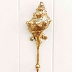 a gold door handle on a white door