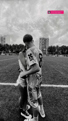 a man and woman embracing on the field