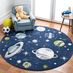 a child's room with a teddy bear sitting on a chair in front of the rug