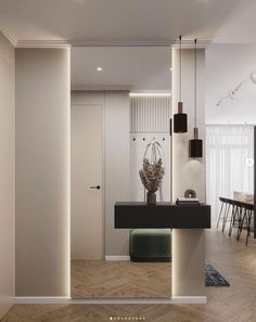 an open living room with white walls and wood flooring, along with modern furniture