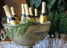 champagne bottles in an ice bucket on a table