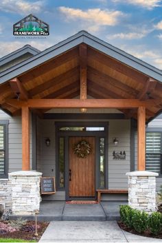 the front entrance to a house with a wooden door and porch overhanging it