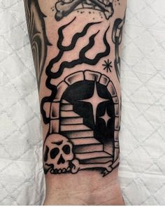 a person with a tattoo on their arm that has a skull and stairs in it