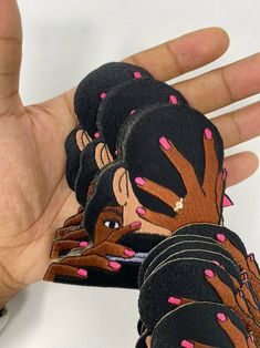 a hand is holding several stickers with pink sprinkles on them