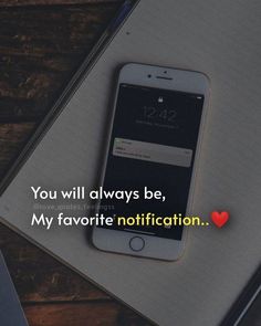 an iphone sitting on top of a desk next to a notepad with the words you will always be, my favorite notification