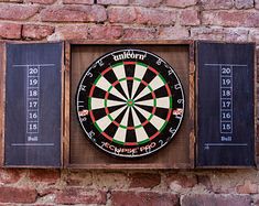 a dart board mounted to the side of a brick wall