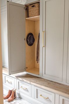 an open cupboard with shoes and hats on the counter in front of it, next to a pair of slippers