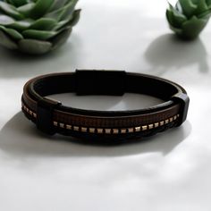 Elevate your style with this Men's Leather Bracelet featuring a sleek magnetic clasp. Crafted from high-quality genuine leather, this bracelet offers both durability and a timeless look that complements any outfit. The magnetic clasp ensures a secure fit and easy wear, making it perfect for everyday use or special occasions. Key Features: Premium Quality: Made from genuine leather for a durable and comfortable fit. Magnetic Clasp: Secure and easy-to-use magnetic clasp for convenience. Stylish De Rectangular Leather Bracelets, Classic Rectangular Leather Bracelets, Classic Rectangular Leather Bracelet, Leather Bracelet With Black Band For Everyday, Everyday Leather Bracelets With Black Band, Rectangular Leather Bracelets For Everyday, Classic Brown Bracelet For Everyday Use, Classic Brown Bracelets For Everyday Use, Classic Brown Bracelets For Everyday