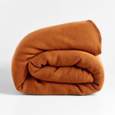 an orange blanket folded on top of each other