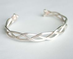 A personal favorite from my Etsy shop https://www.etsy.com/listing/123699222/silver-braid-bracelet-braid-cuff-irish Silver Braided Bracelet, Silver Braided Ring, Diy Wire Jewelry Rings, Braid Cuffs, Braid Bracelet, Wire Jewelery, Wire Wrap Jewelry Designs, Wire Diy, Bijoux Fil Aluminium