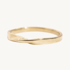 a gold ring with a curved design on it