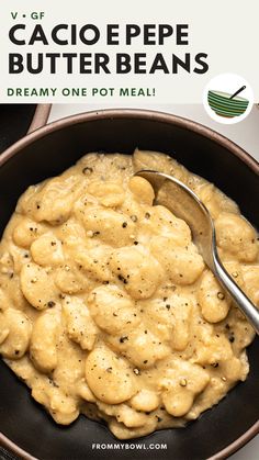 a close up of a bowl of food on a table with a spoon in it