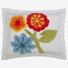 a white pillow with colorful flowers on it