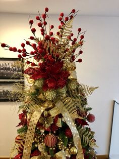 a christmas tree decorated with red and gold ornaments