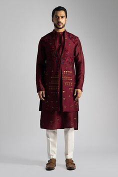 Deep red long nehru jacket with a button at the waist and resham and sequin embroidery. Paired with a long embroidered kurta and cream pant. - Aza Fashions Festive Kurta With Stand Collar For Fall, Festive Fall Kurta With Stand Collar, Festive Nehru Jacket With Stand Collar For Fall, Traditional Red Nehru Jacket For Fall, Fitted Red Kurta For Fall, Red Festive Winter Kurta, Red Winter Festive Kurta, Winter Festive Red Kurta, Designer Nehru Jacket For Festive Winter Occasions