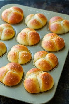 freshly baked hot cross buns sitting in a muffin tin ready to be baked