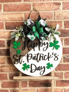 a wooden sign that says happy st patrick's day with shamrocks on it