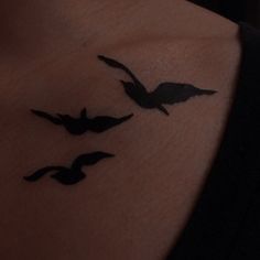 a woman's chest with three birds on it