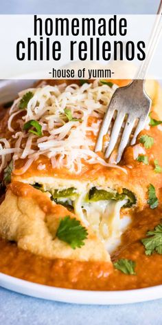 a white plate topped with enchilada covered in sauce, cheese and cilantro