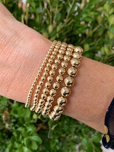 "Our classic 14k gold filled bead bracelet is a perfect addition to a dainty stack. The beads are strung on a premium stretch cord. For best fit, measure your wrist at the wrist bone with a measuring tape or string. Add 1/2\" to that measurement for a snug fit, 3/4\" - 1\" for a comfort fit, or 1\" or larger for a loose fit. Your bracelet will arrive in a gift box. Deluxe gift wrap is available at checkout. Listing is for one bracelet. About gold filled jewelry: Gold filled jewelry is second onl Sydney Fashion, Gold Bead Bracelet, Mens Gold Bracelets, Gold Bead Bracelets, Ball Bracelet, Unisex Accessories, Layered Bracelets, Measuring Tape, Add Ons