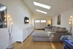 a living room filled with furniture and a flat screen tv mounted to the side of a wall