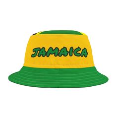 This Jamaica bucket hat is a patriotic national team fan hat for any sport with the Jamaican flag colors of green, yellow and black and the word "Jamaica" on a polyester bucket hat. Makes a perfect bucket hat for a national holiday, sporting event, summer hat, Jamaican party or Halloween party costume, Halloween costume, Jamaican flag hat, team Jamaica hat, football fan hat, game day hat, soccer fan hat, soccer fan apparel, Jamaica hat, Jamaican hat, Jamaica cap, Jamaica shirt accessories, Rasta Outdoor Letter Print Bucket Hat, Green Sports Bucket Hat, Green Bucket Hat For Sports, Green Baseball Cap For Summer Sports Events, Sports Fan Hats With Letter Print And Curved Brim, Multicolor Snapback Hats For Sports Events, Adjustable Yellow Sports Hat, Green Baseball Cap For Fan Gear, Yellow Sports Trucker Hat With Curved Brim