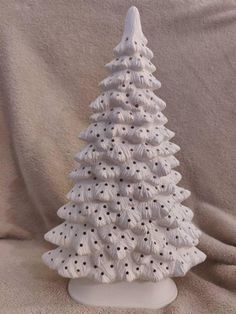 a white ceramic christmas tree sitting on top of a table