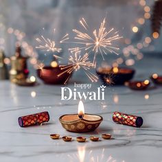 happy diwali greeting card with lit candles and sparklers on marble table top