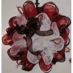 a red and white wreath hanging on the wall