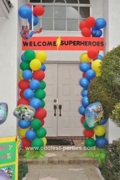 an entrance to a school with balloons and welcome signs on the front door for children's parties