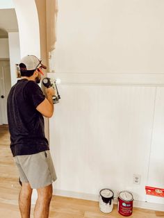 a man is painting the walls in his house