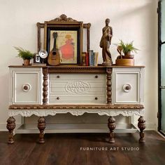 an old dresser has been painted white and is decorated with plants, books, and other things