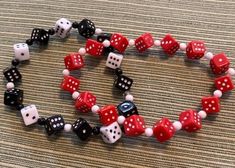 I have been sold out of my dice jewelry for a while and finally made time to make more and post it. This set includes 2 stretch bracelets and 2 pair of earrings that match. The bracelet fit about 7 1/2 = 8 inch wrists. If you like your bracelets loose, hanging on the top of your hand, then they will work for down to 7 inch wrists. One bracelet is red dice with white dots, other bracelet is black dice with white dots and white dice with black dots. There is a pair of earrings in red dice and a pair of earrings with black dice. Priced to sell. These are lightweight as all the dice are acrylic. Don't miss these.  Split up for gives if you want to stretch your money. Dice Jewelry, Red Dice, Black Dots, Matching Earrings, Stretch Bracelets, Jewelry Set, Jewelry Sets, Black And Red, Bathing Beauties