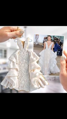 a person holding up a wedding dress in front of a photo with the bride's gown