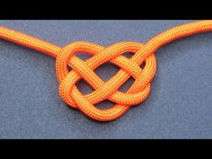 an orange knot is shown on a blue surface, with the end of it being knotted