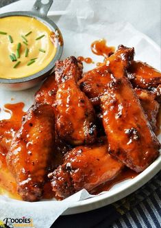 chicken wings with dipping sauce on the side