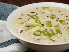 a white bowl filled with cheese and green onions